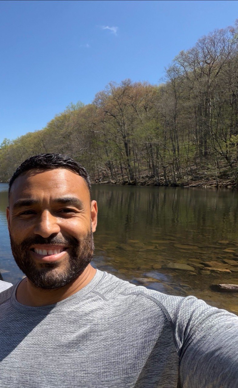 Frank Smith III selfie near a quiet wooded lake