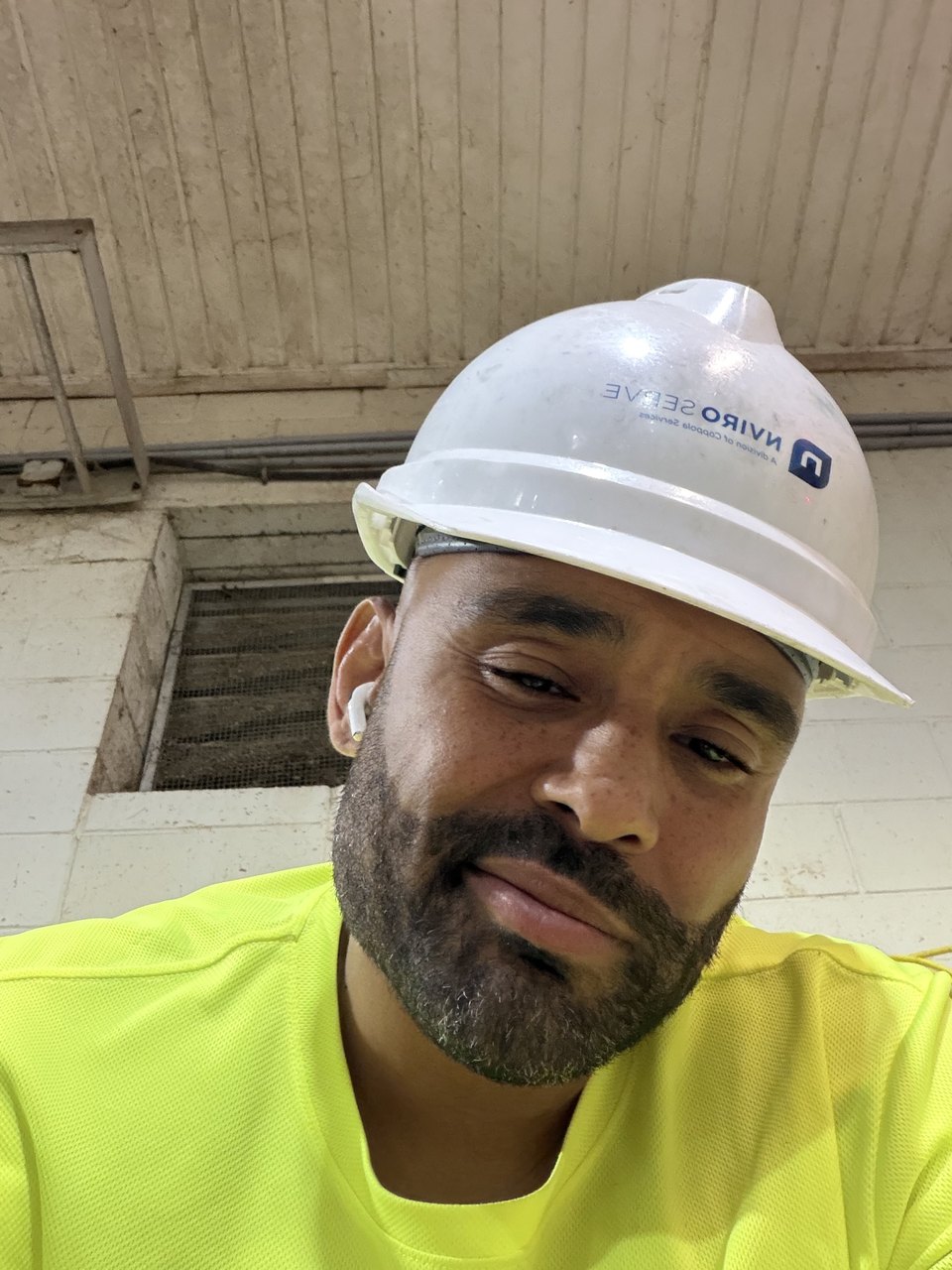 Frank Smith III wearing a hard hat during field operations work