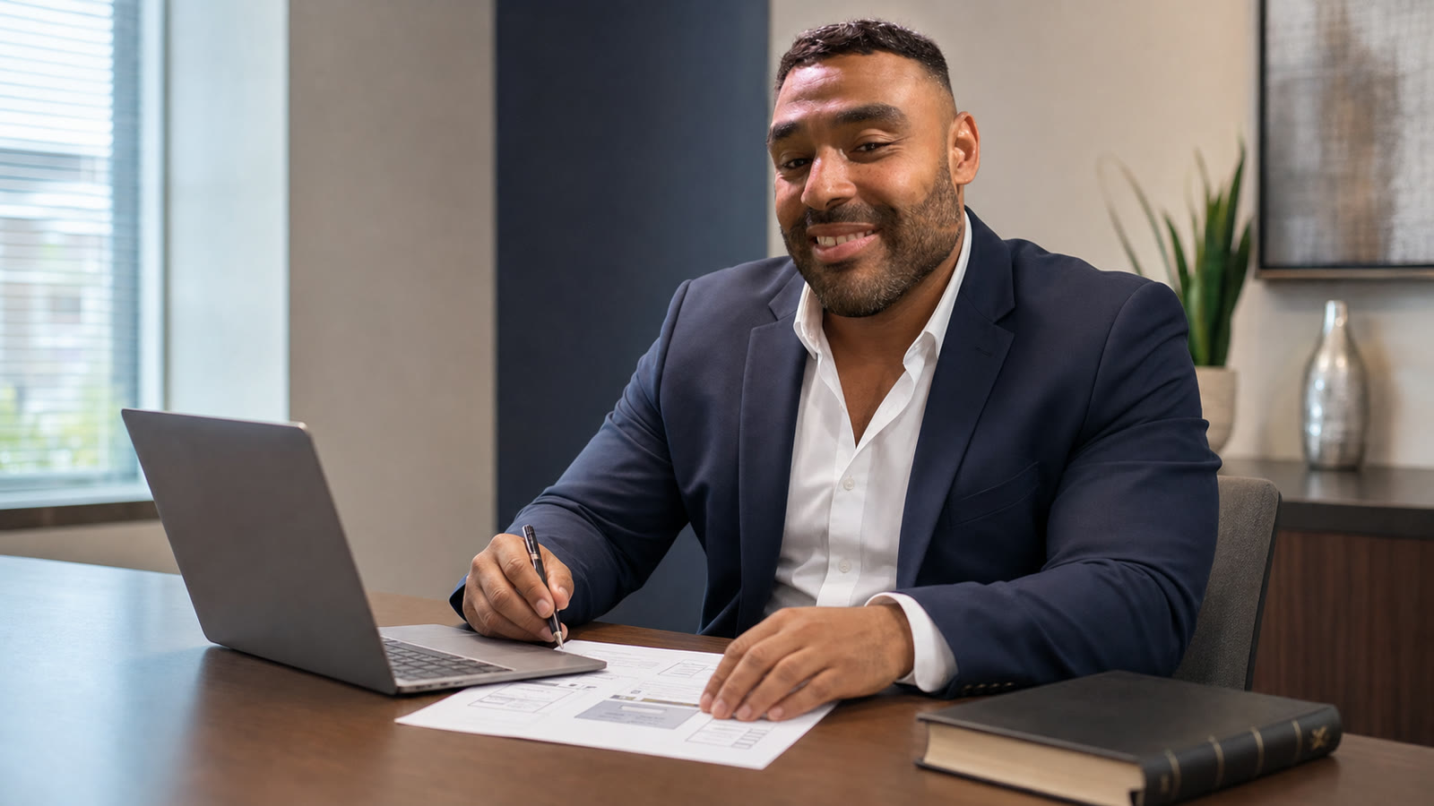 Frank Smith III planning the Greater Expectation community-service website at a desk.