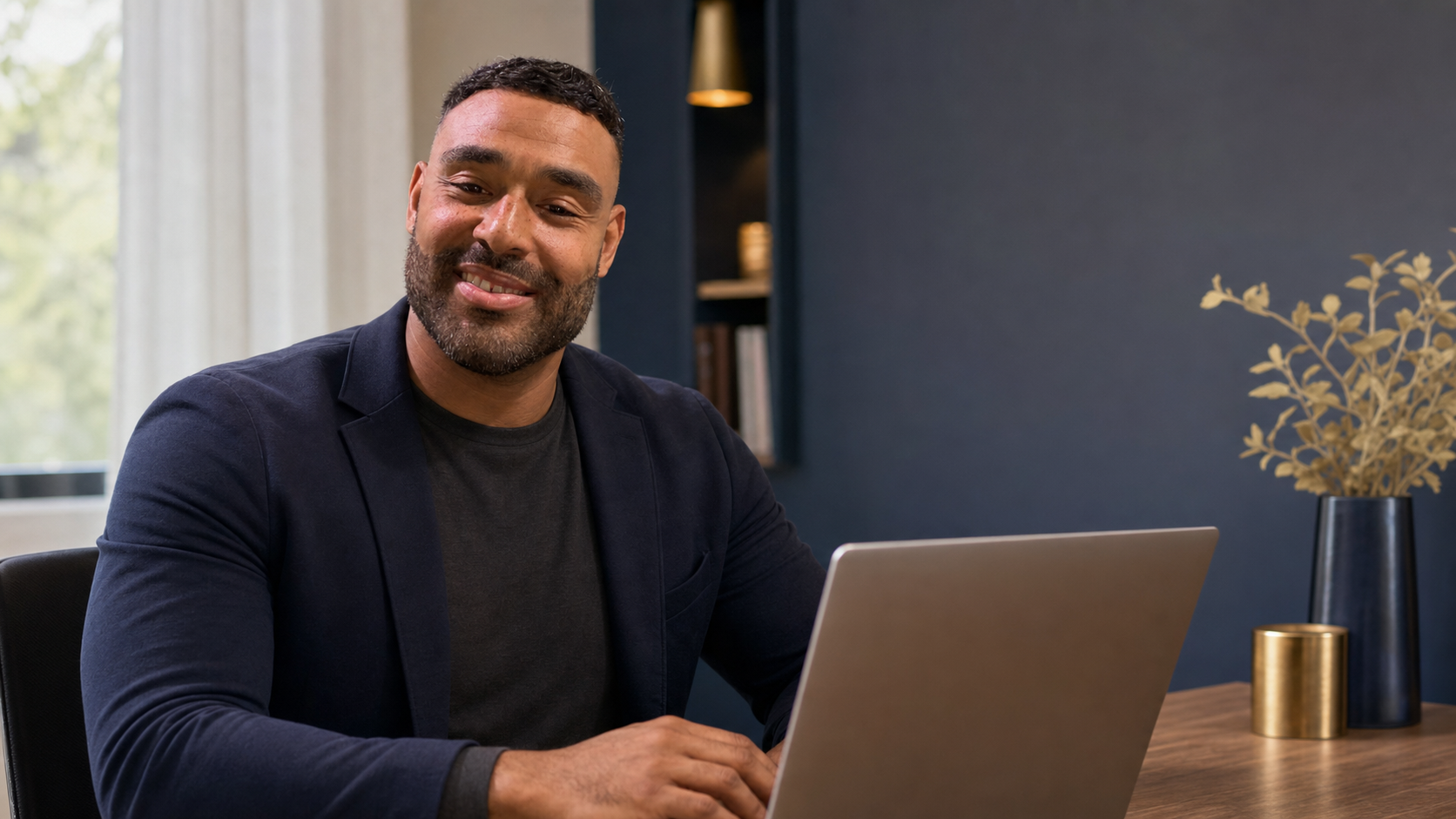 AI-assisted likeness of Frank Smith III reviewing the Il Veliero website project at a laptop.