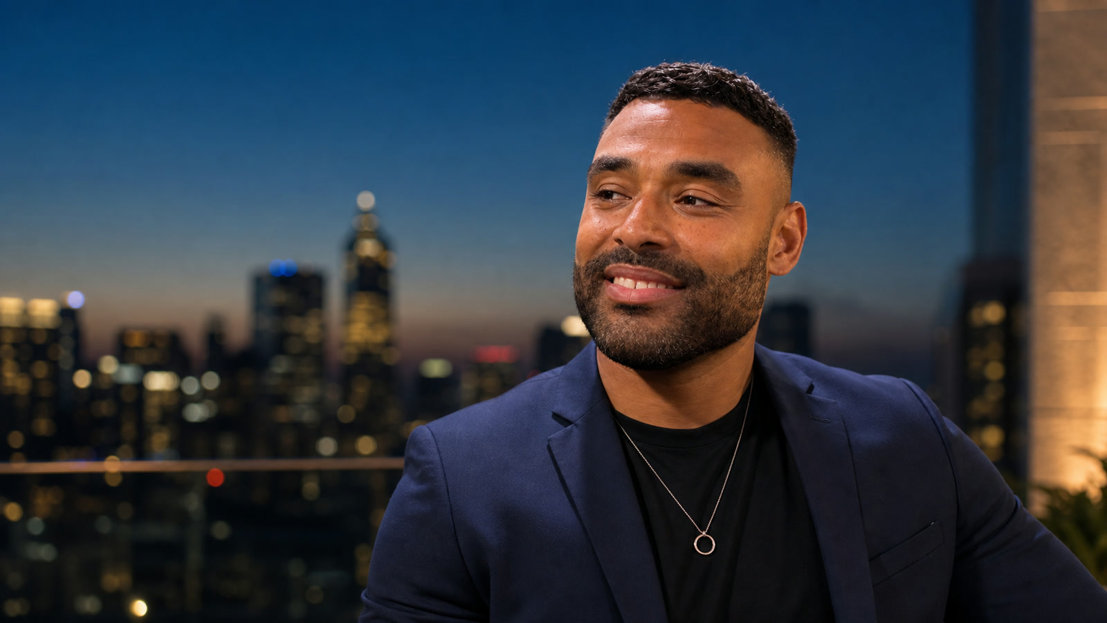 Frank Smith III in tailored professional clothing with a city background