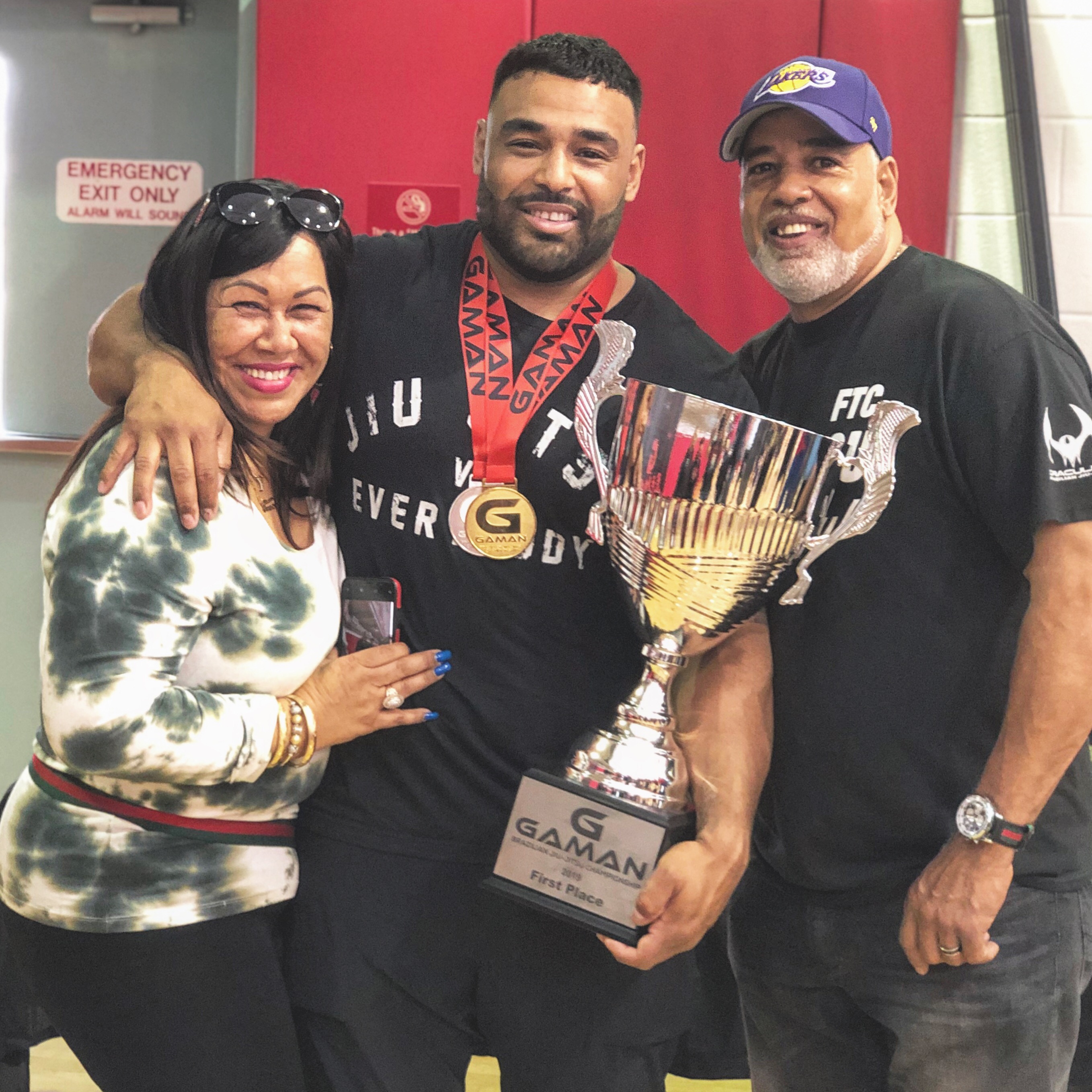 Frank Smith III holding a jiujitsu trophy, celebrating discipline, fitness coaching excellence, and transformative mindset.