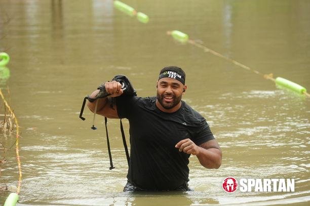 Frank Smith III crossing water during a Spartan race