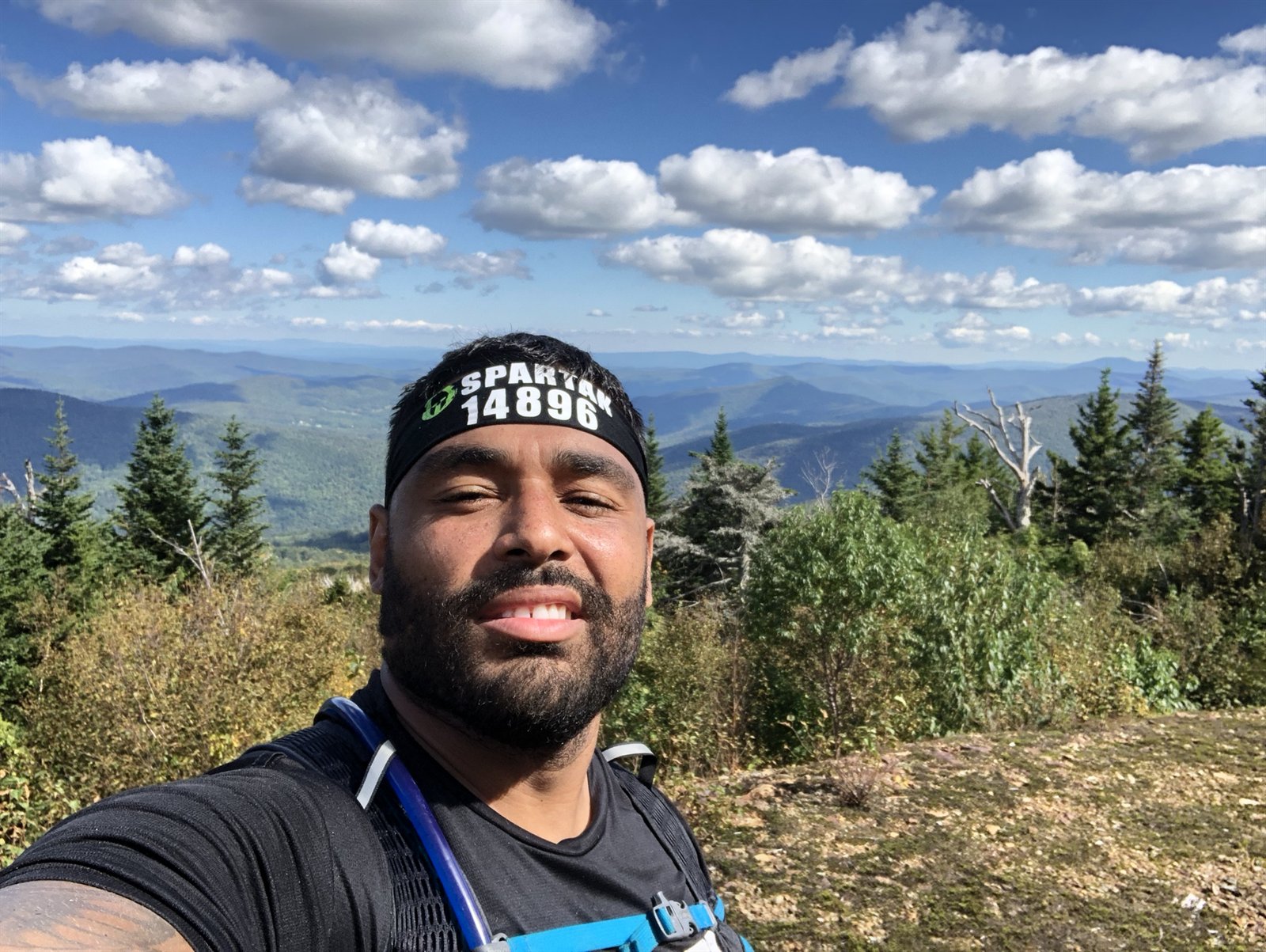 Frank Smith III on a mountain top after a Spartan race